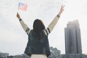 Image by freepik Anonymous Woman Raising Hands American Flag Honor Independence Day