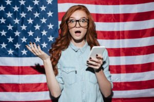 image by drobotdean on freepik Shocked Redhead Young Lady Standing Usa Flag