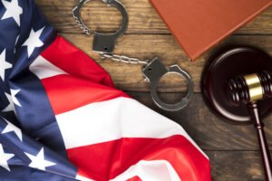 Image by freepik Top View American Flag With Handcuffs Gavel